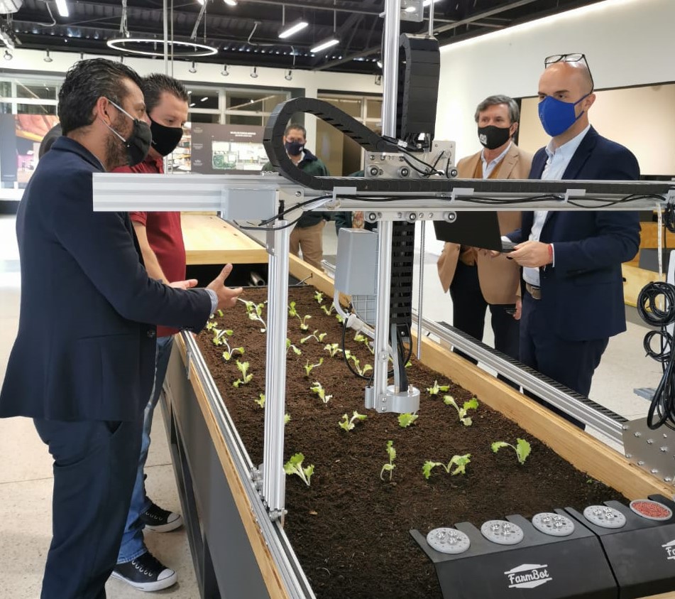 Menghini (primero de derecha a izquierda) conoció en su visita a la sede central del IICA, el FarmBot que recientemente instaló el Instituto en el Centro de Interpretación del Mañana de la Agricultura (CIMAG). Estuvo acompañado del Director General, Manuel Otero (a su lado), y personal técnico de TIC's (al frente) del organismo especializado en agro y ruralidad.